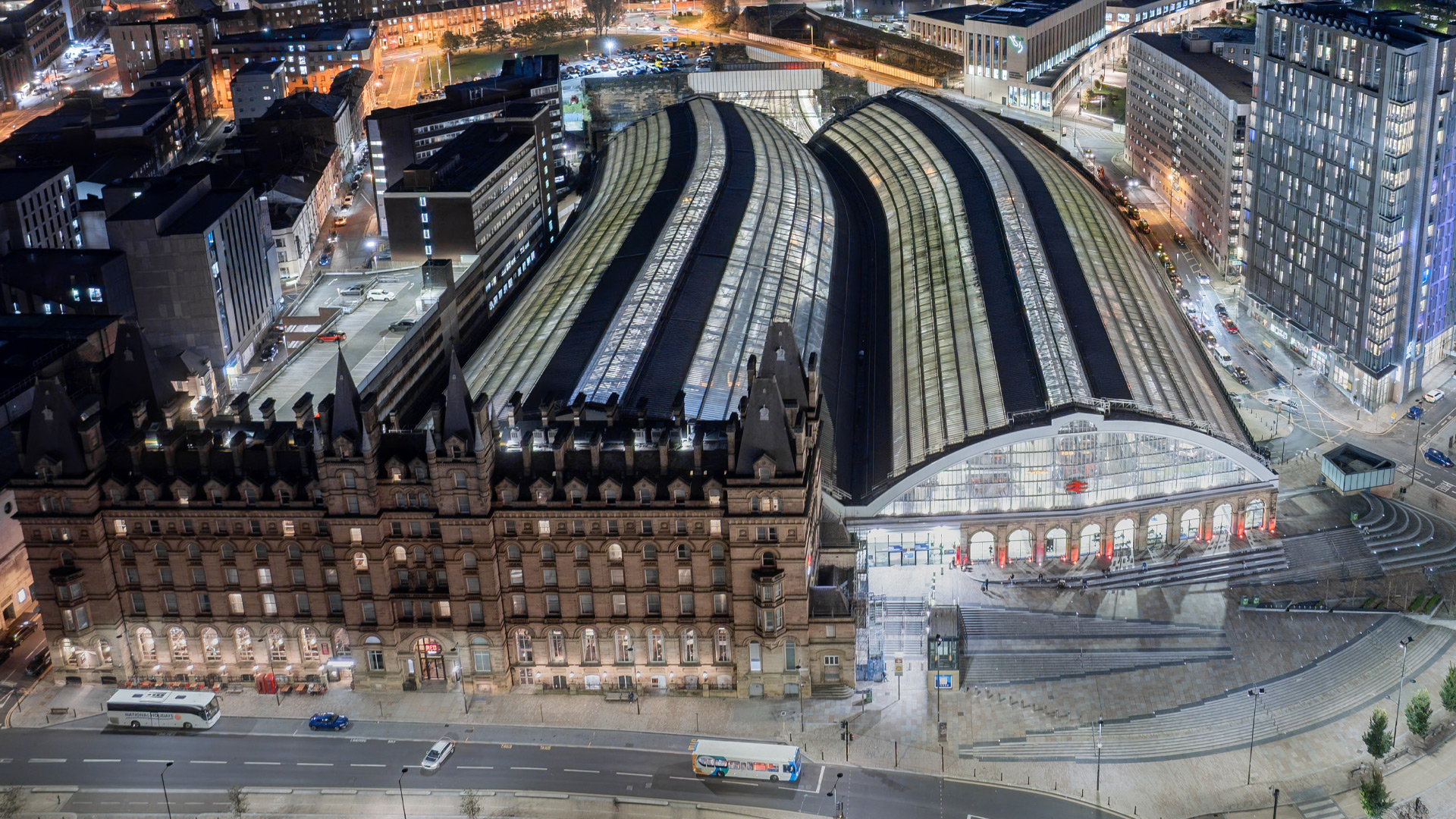 Aerial view of Liverpool Lime Street station at night, showing the glass train shed roofs and the North Western Hall following the £140m redevelopment